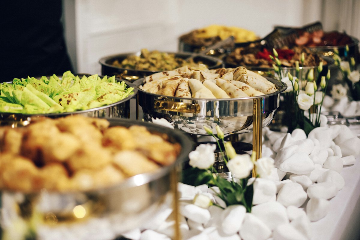 Hot food laid out for an office buffet