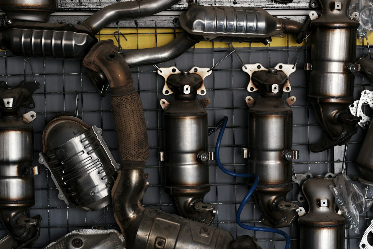 Exhaust and catalytic parts on a workshop wall