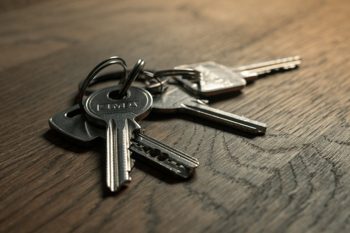 A set of door keys on a desk