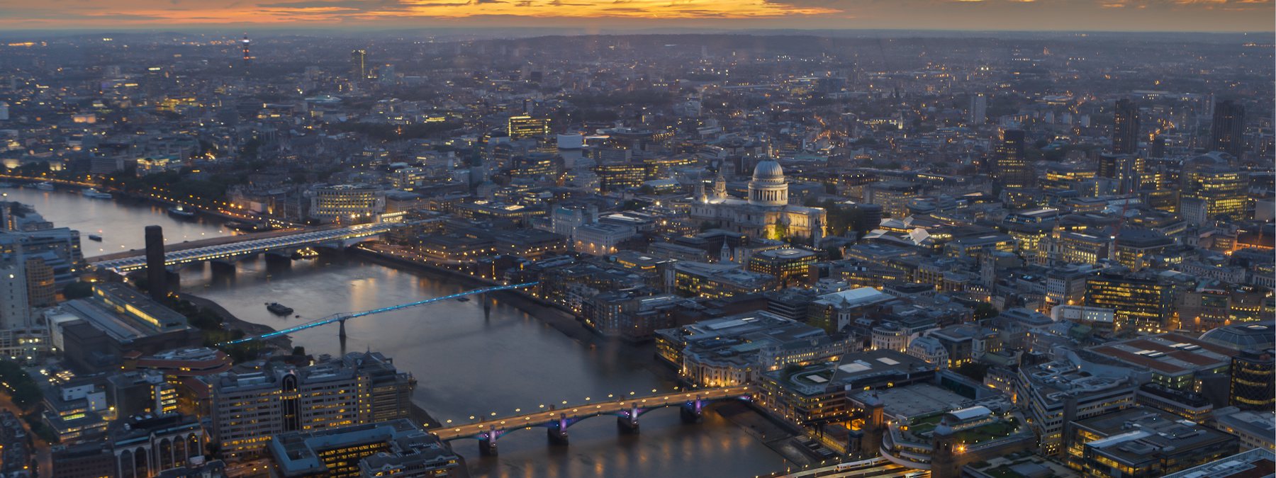 London from above at dusk, the Thames running through it