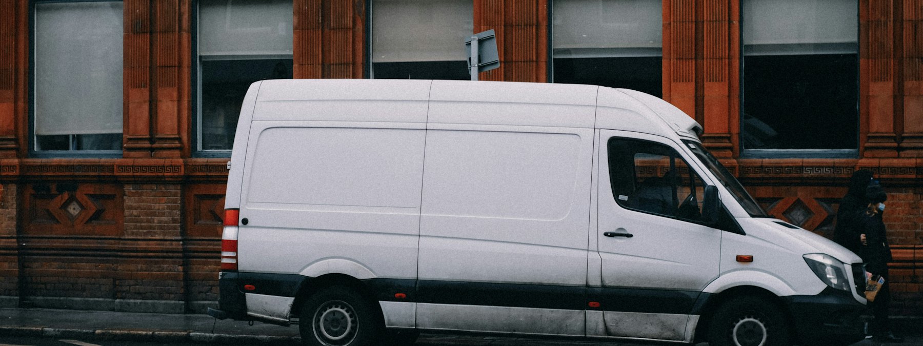 A plain white van on a city street